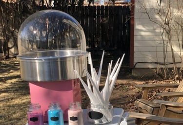 a pink cotton candy machine with a clear dome and three containers of flavored sugar