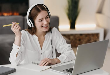 a woman with headphones and headphones on a laptop