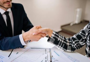 a man and woman shaking hands in a meeting