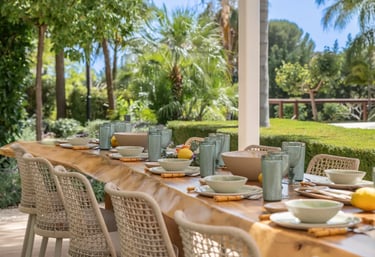 Al fresco dining terrace with wicker chairs at Villa Serenity