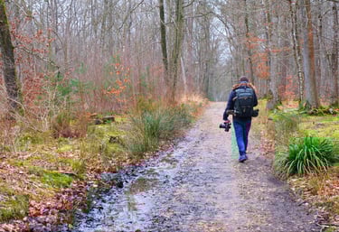 a man walking down a path with a backpack on his back
