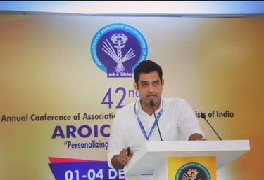 Dr. Abhishek Krishna, oncologist in Mangalore speaking at AROI conference.