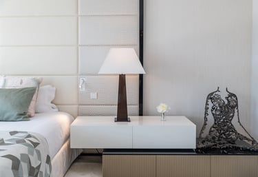 Modern luxury bedroom detail with lamp, sculpture, and soft tones at Villa Serenity
