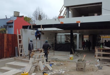 a man standing in front of a house with a roof