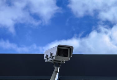 a camera mounted on a wall near a building