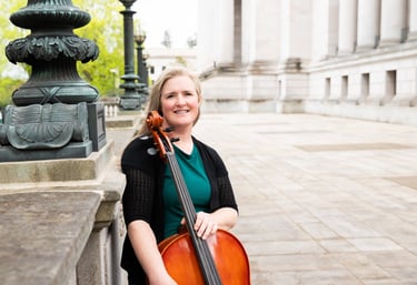 Private lesson teacher holding a cello