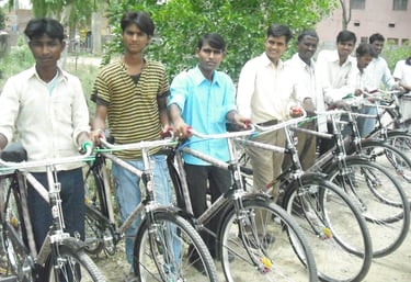 a group of men standing around a row of bicycles