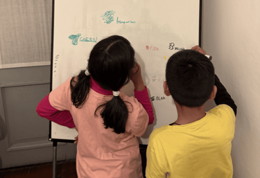 niños escribiendo en una pizarra