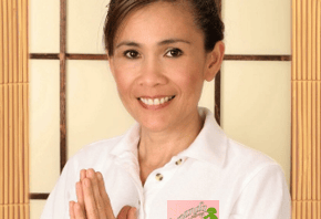 a woman in a white shirt and a pink flower