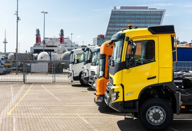 a truck parked in a parking lot with a large truck