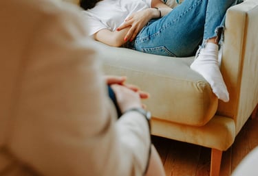 a woman sitting on a couch in a living room