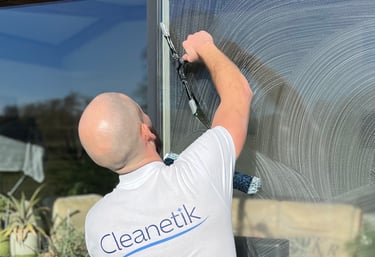 a man in a white shirt is cleaning a window