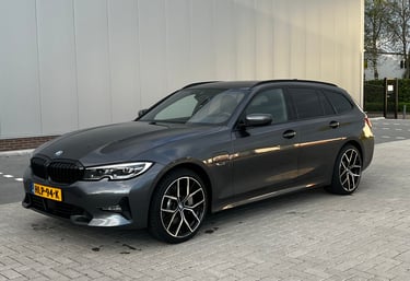 a grey bmw wagon parked on a brick wall