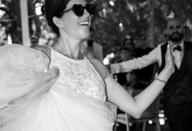 a woman in a wedding dress dancing with a man in a suit