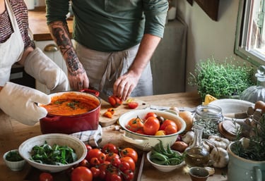 a man and woman in aprons preparing food
