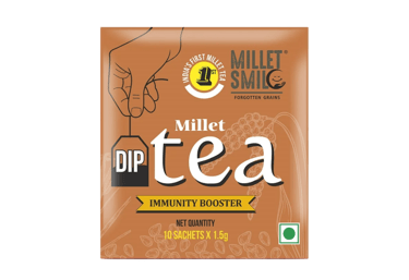 Box of millet tea with a hand holding a tea bag