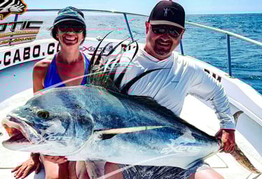 a man and woman holding a fish on a boat