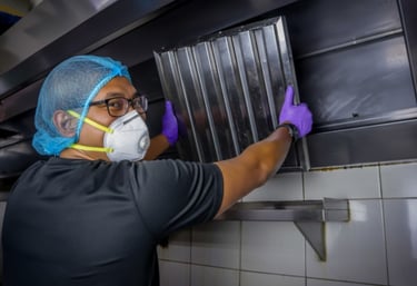 a person installing a hood filter
