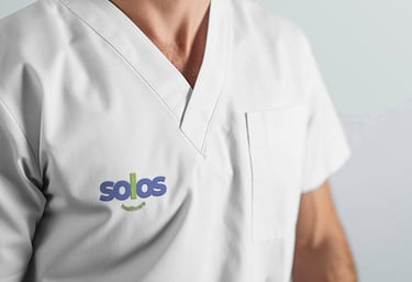 A healthcare uniform with the Solos logo on