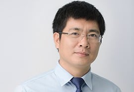 a man in a blue shirt and tie tie