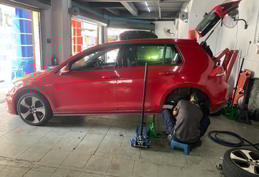 a man working on a car in a garage