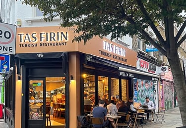 a restaurant with a bicycle parked in front of a tree