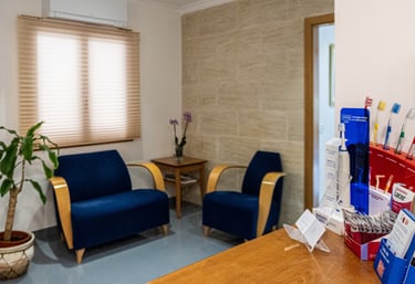 a room with a desk and chairs and a plant