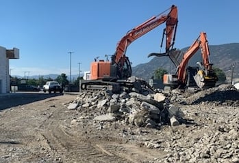 Two excavators sorting and crushing concrete