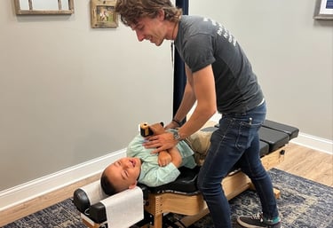 Child receiving chiropractic adjustment for sensory processing issues