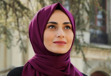 a woman wearing a purple scarf and a black top