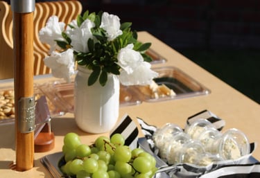 Fruit and cheese on a bar cart with flowers