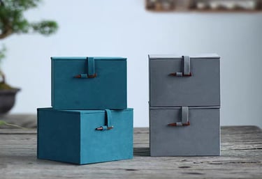 Four gift boxes arranged on a table.