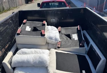a truck bed with a couch and pillows