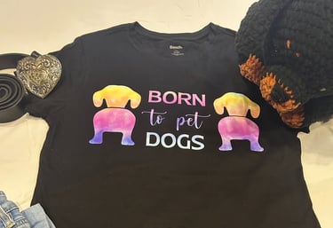 a tshirt that says "born to pet dogs" paired with a belt and jeans along with a stuffed rottweiler