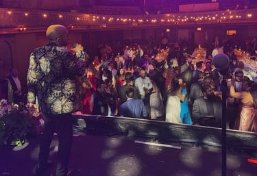 LuxeBand singer performing on stage at a historic venue