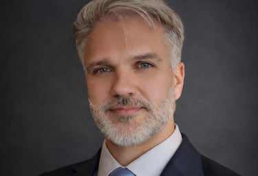 a man in a suit and tie with a blue tie Karolis Suminas