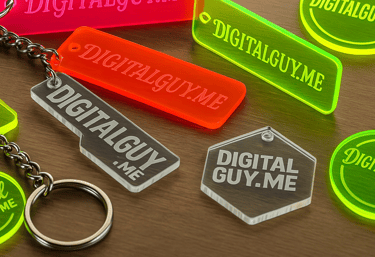 Acrylic keychains with DigitalGuy.me logo. Laser engraved promo items for local tech branding.