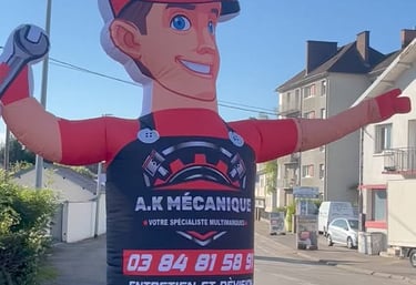 a man in a red and black suit and a large inflatable sign
