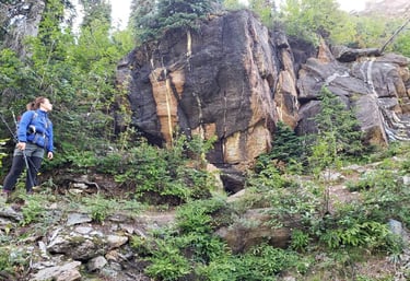 andree hiking looking up at a big rock