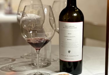 a wine bottle and wine glasses on a table