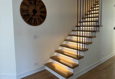 Modern floating oak staircase renovation with LED under-lighting and custom black metal railings