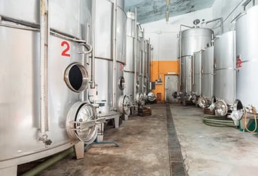 a large group of metal tanks in a large room