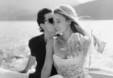 a man and woman kissing on a boat in Lake Como