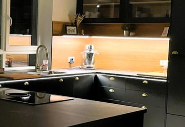 a kitchen with a black counter top and a kitchen island