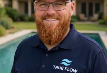 Geoff from True Flow Pool Solutions standing by a backyard pool in Round Rock, Texas.