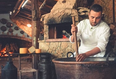 Man making traditional cheese in copper pot, Sardinia food culture