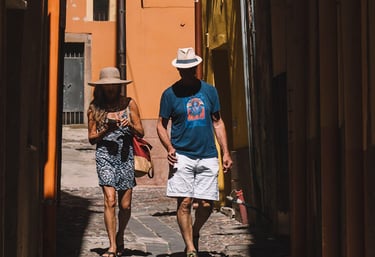 Tourists walking through narrow alleys in Bosa, Sardinia