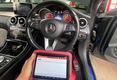 a person sitting in a car with a tablet and a tablet