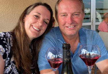 a man and woman are sitting at a table with wine glasses