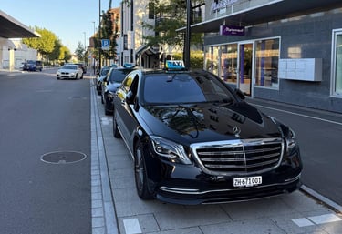 Black Mercedes S-Class parked in a row with two Mercedes E-Classes